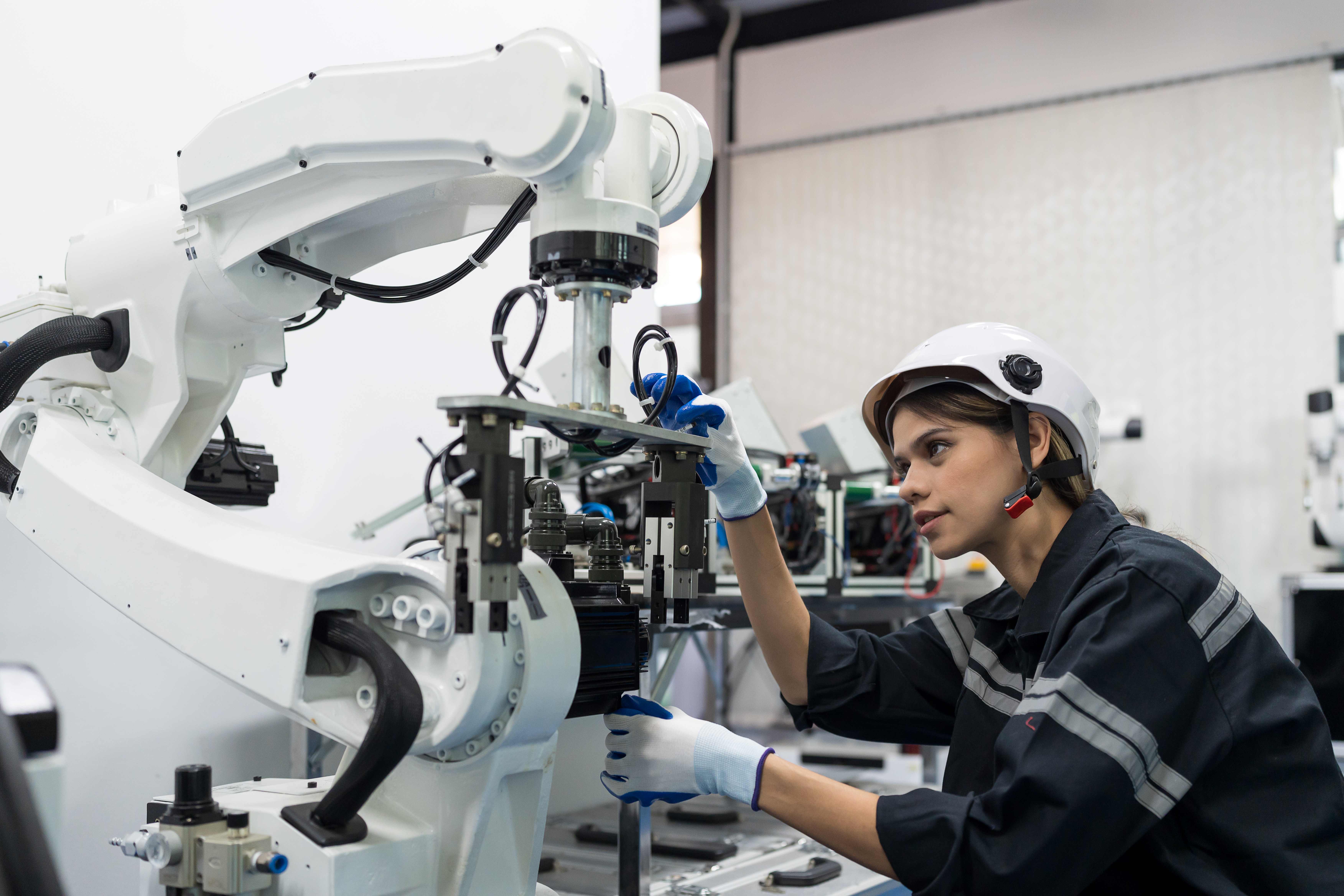Engineer working with robot in lab
