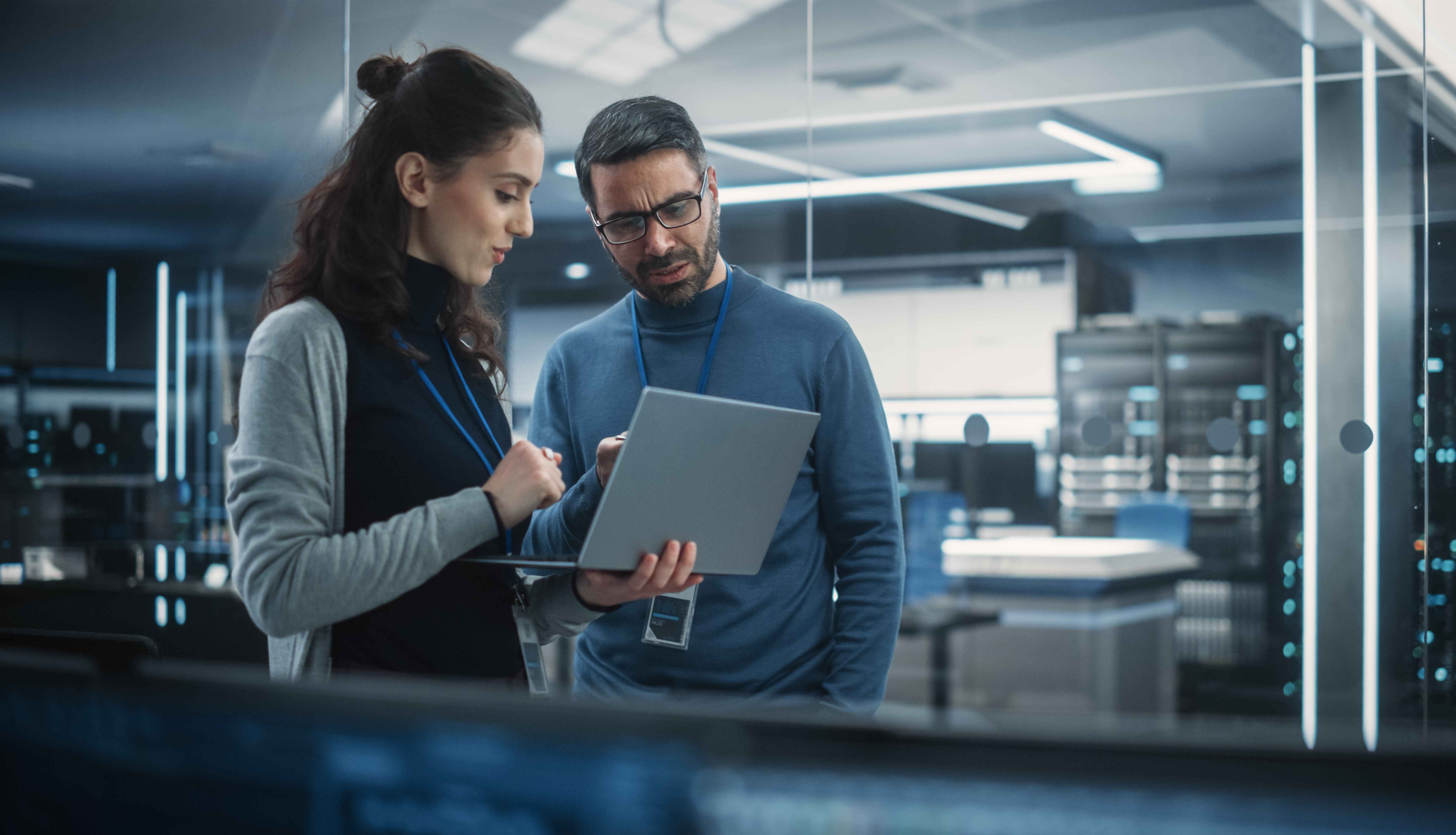 two engineers discussing 5G network planning in a lab