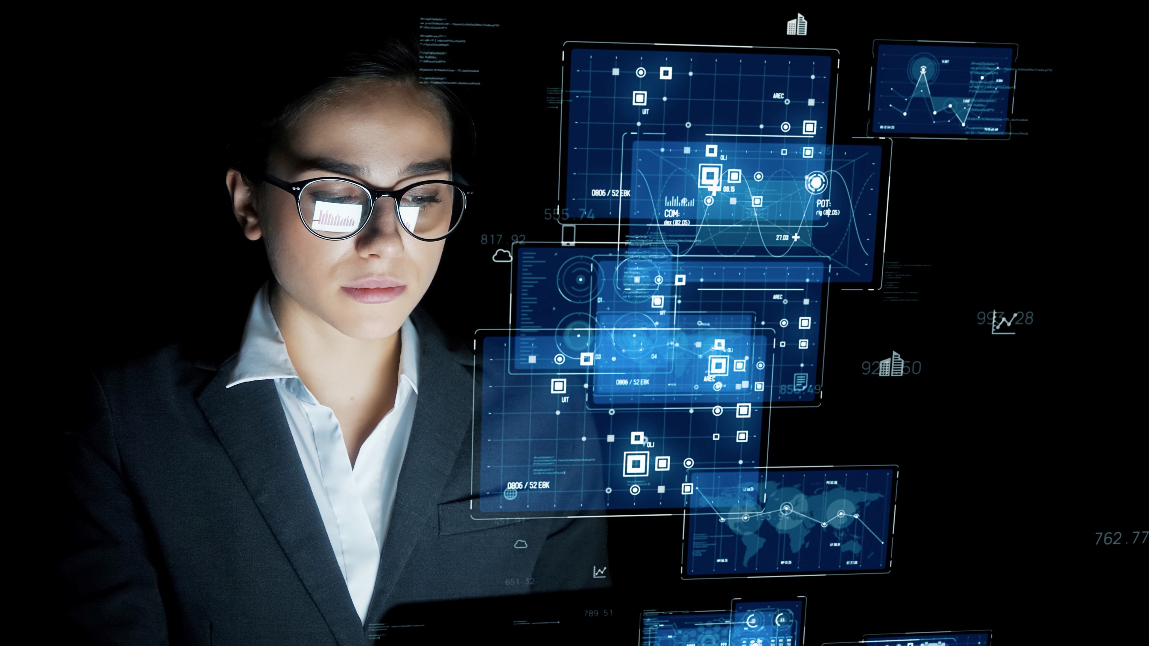 woman doing edge computing on numerous screens