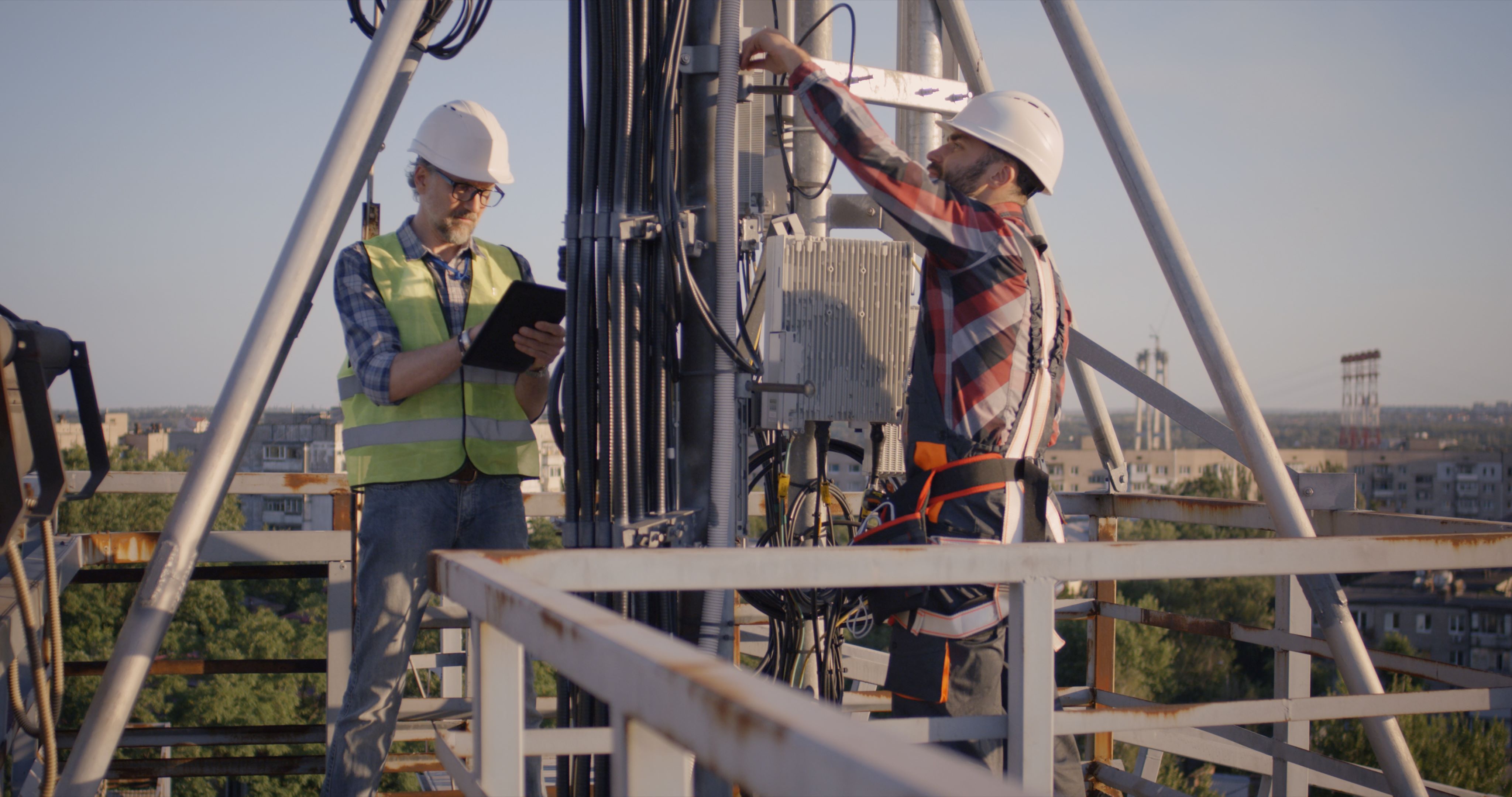 Engineers on roof working on 5G equipment